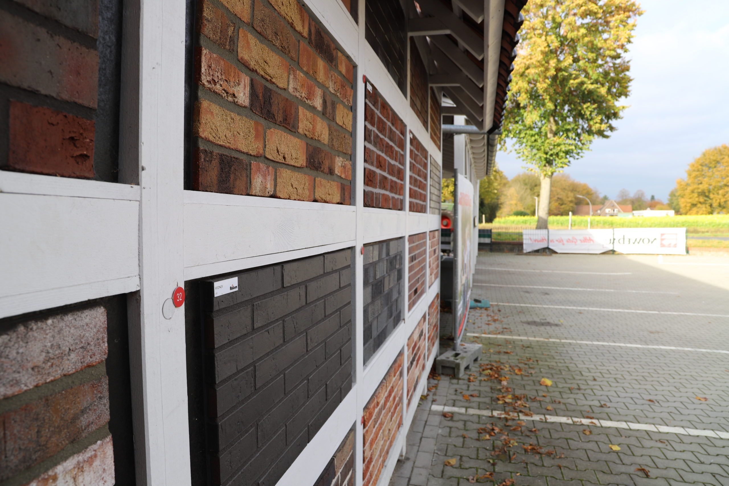 Die Außenwand eines Baumarkts zeigt verschiedene Mauerwerksmuster, ideal zur Auswahl von Baustoffen für den Rohbau.